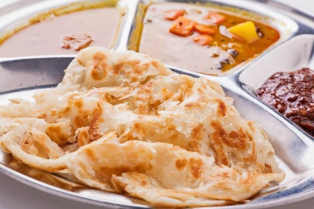 Top 10 Must-Try Street Foods in Kuala Lumpur (2025): A Culinary Journey Through KL's Best Street Eats - A Plate of Roti Canai. 